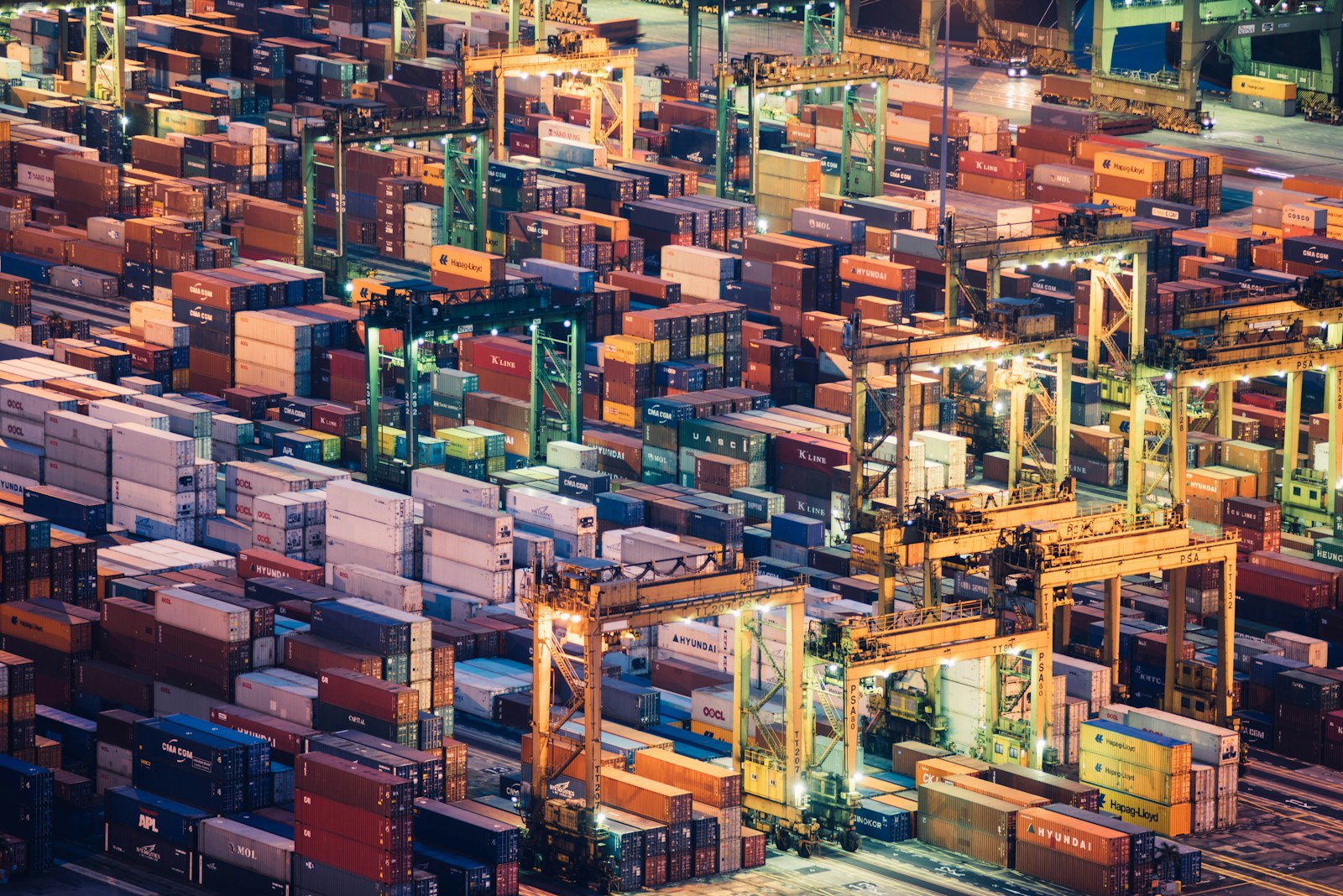 Container stacks at an illuminated freight terminal
